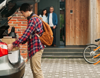 Teenage Boy loads his car's trunk